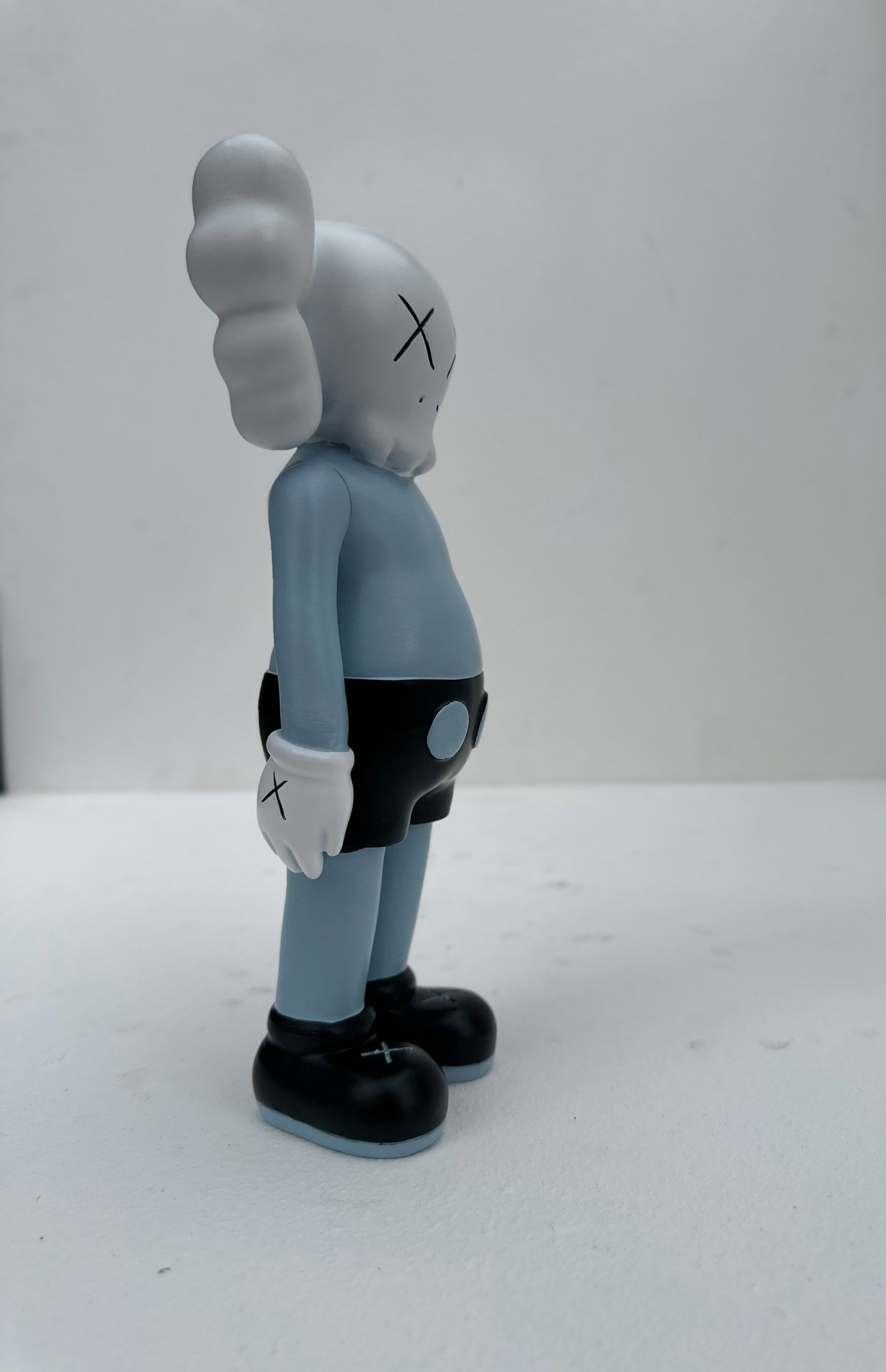 Small standing Kaws doll